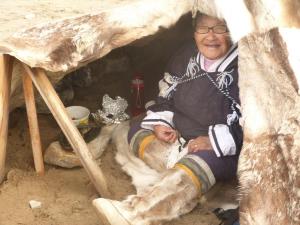 local woman Gjoa Haven, Nunuvut giving out raw narwhal samples
